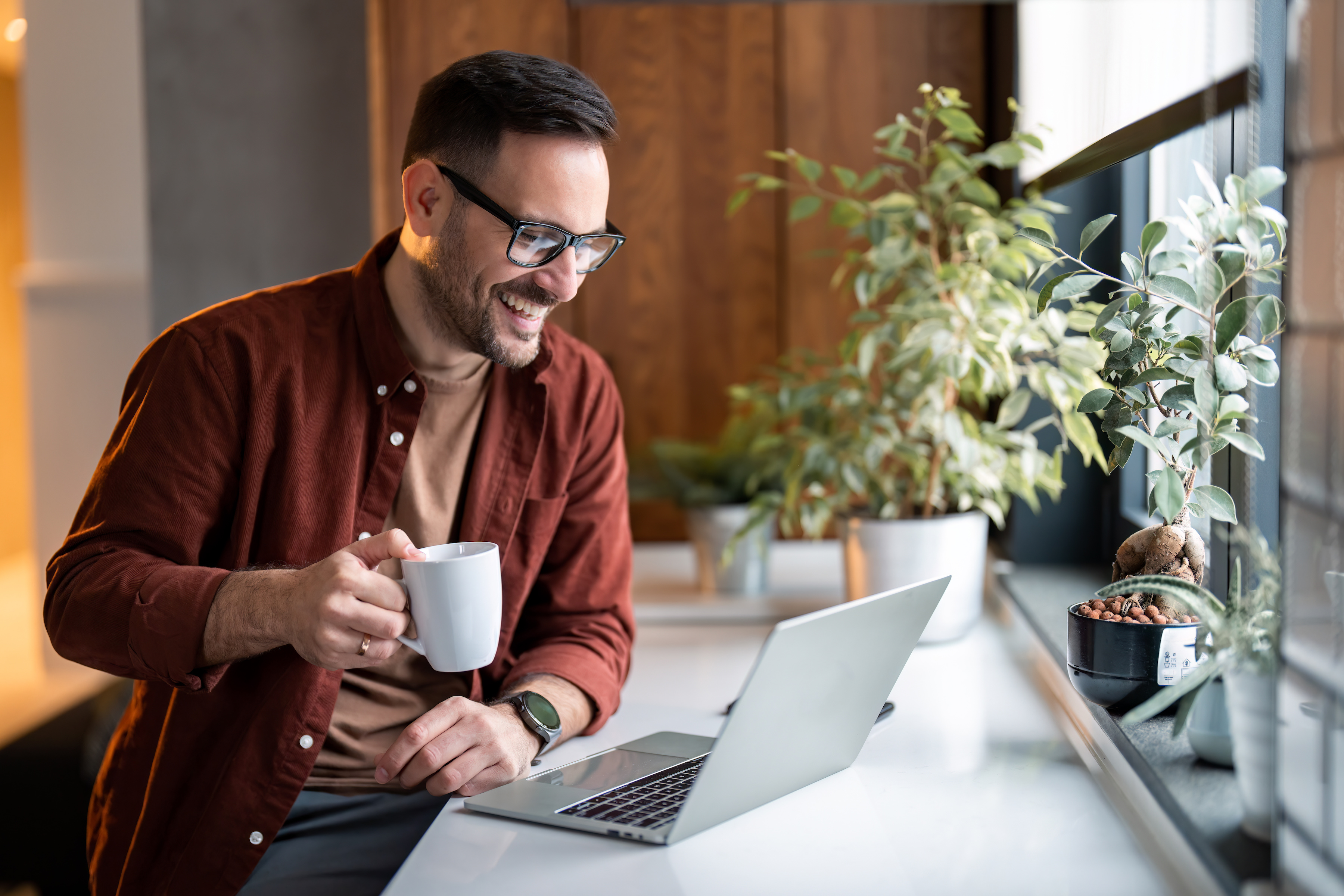 Before you start your business, it's best to see if the name is already being used. This man is checking online as he has a cup of coffee. Businesses can trademark their names nationwide if they register the name with the U.S. Patent and Trademark Office (USPTO).