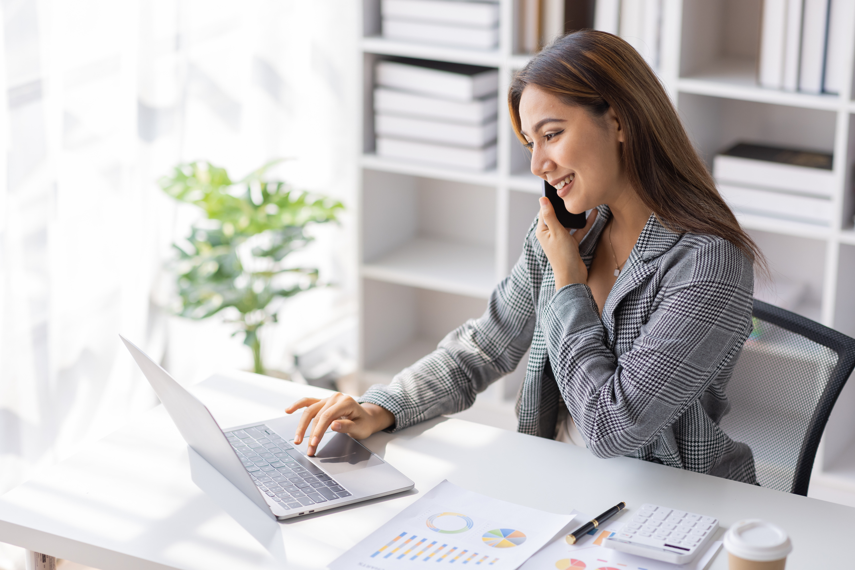 A woman talks on the phone and checks her laptop at the office of her newly formed business. Several states also require DBAs to register, so be sure to check with the Secretary of State.