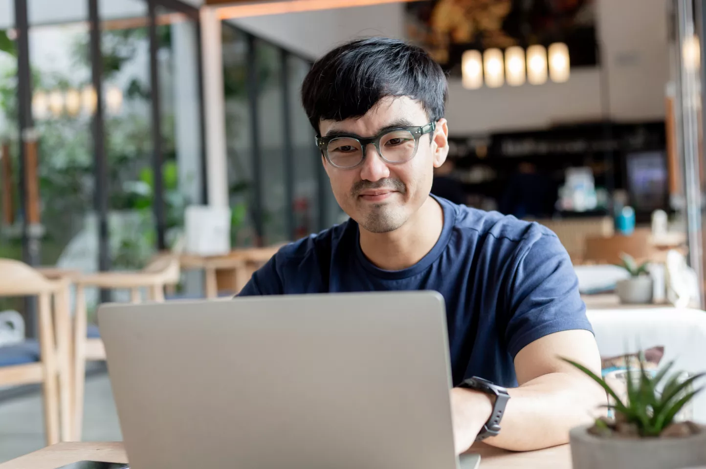 A man looks on his laptop computer to see if the business name he wants to use for his LLC is available.
